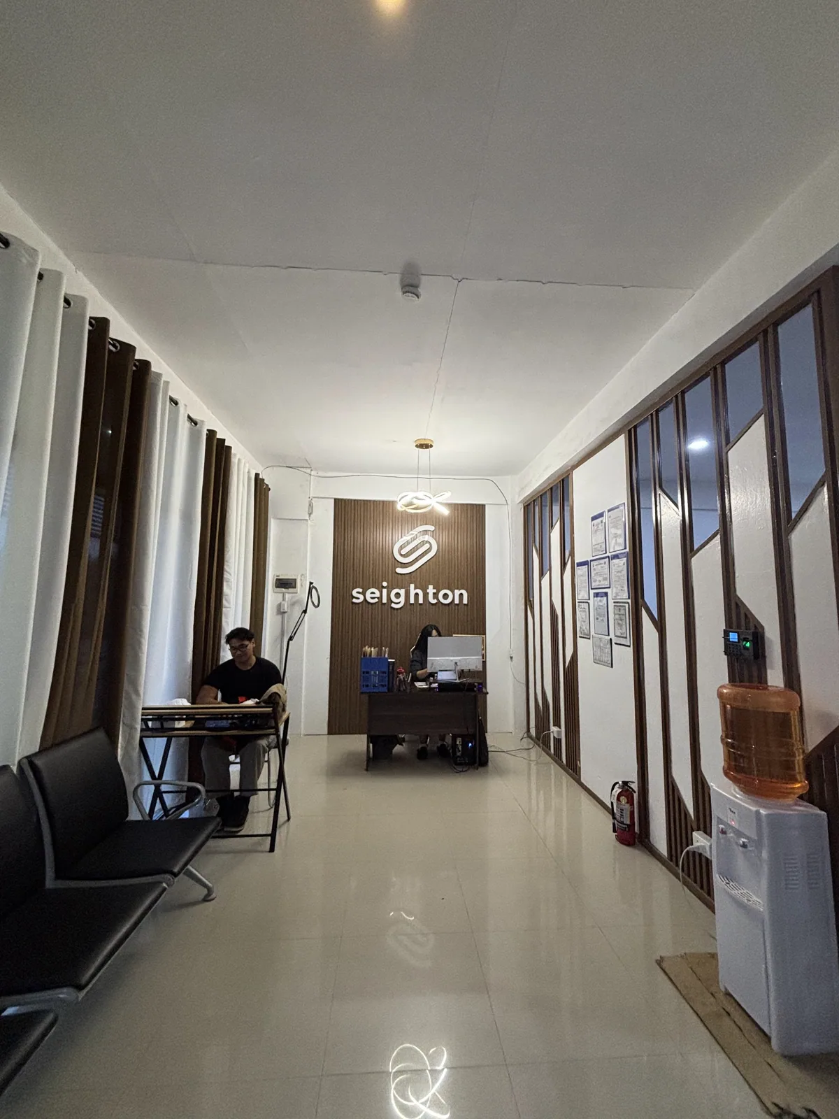 Seighton BPO reception area with the company logo on the wall