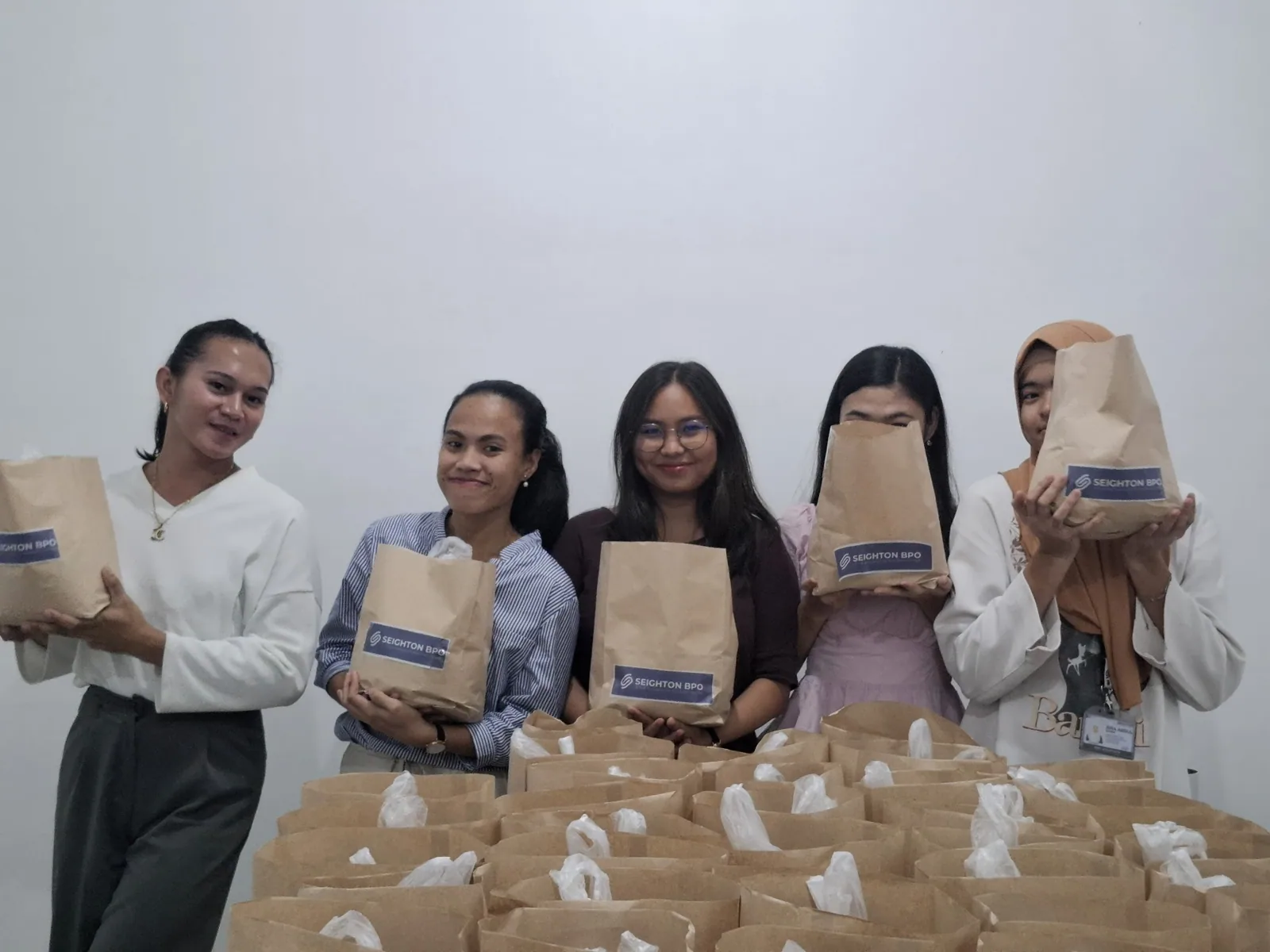 Associates holding branded rice bags